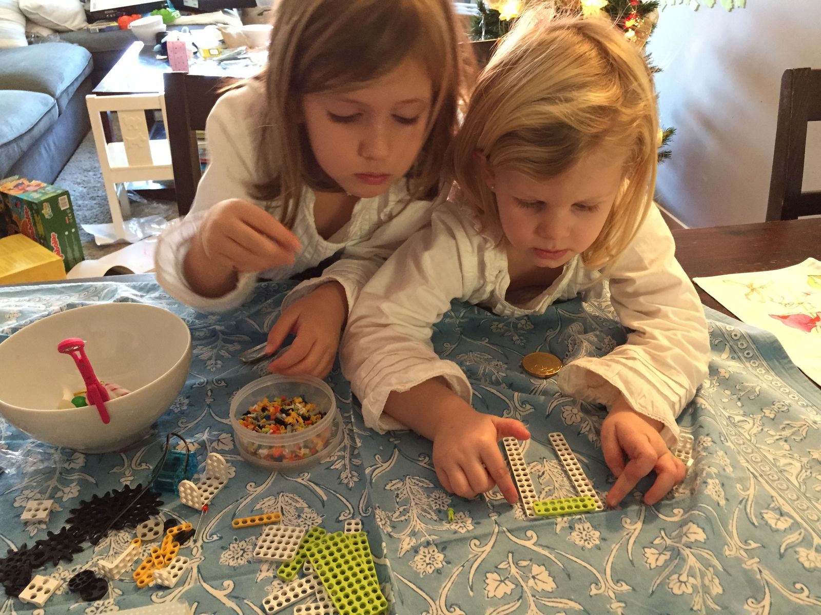 Putting kit parts together at the table with my sister