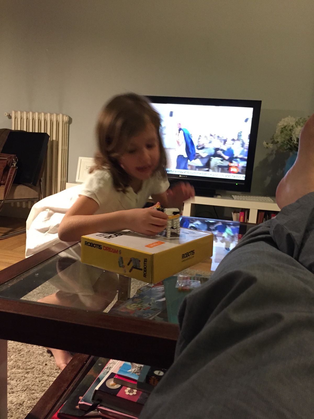 Playing with the robot cow on top of the Robotis Dream kit box